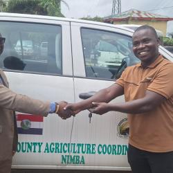 Minister Nuetah handing over the key of one of the vehicles to Nimba CAC