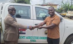 Minister Nuetah handing over the key of one of the vehicles to Nimba CAC