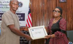 The Minister of Foreign Affairs, Her Excellency Sara Beysolow Nyanti, certificates a retiree