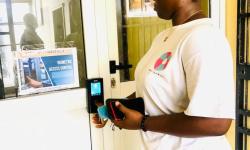 MOT Employee at the Biometric Signing Machine  